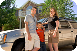 Family standing in front of a car